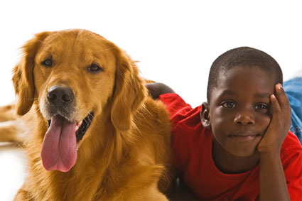 boy and dog cuddling